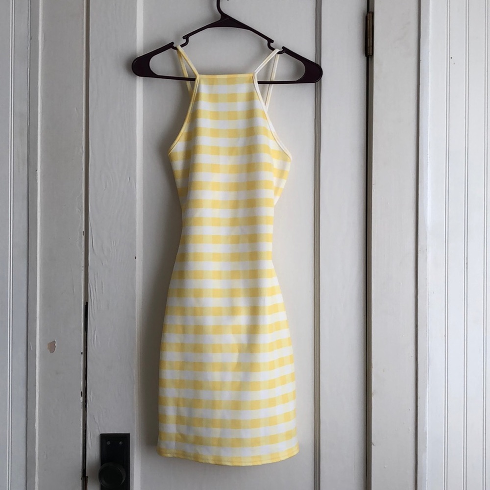 Bright yellow mini dress with cutoff back design